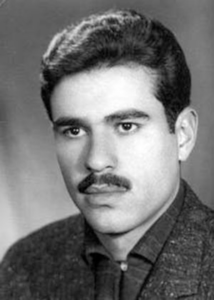 A grayscale portrait of a young man with very dark hair, eyes, and mustache.